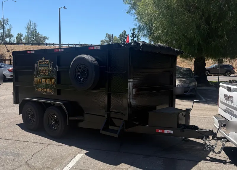 The Jackpot Junk Removal dump trailer hitched and ready for a pickup